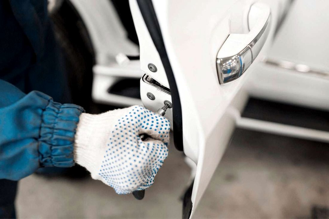 Locksmith working at a vehicle door