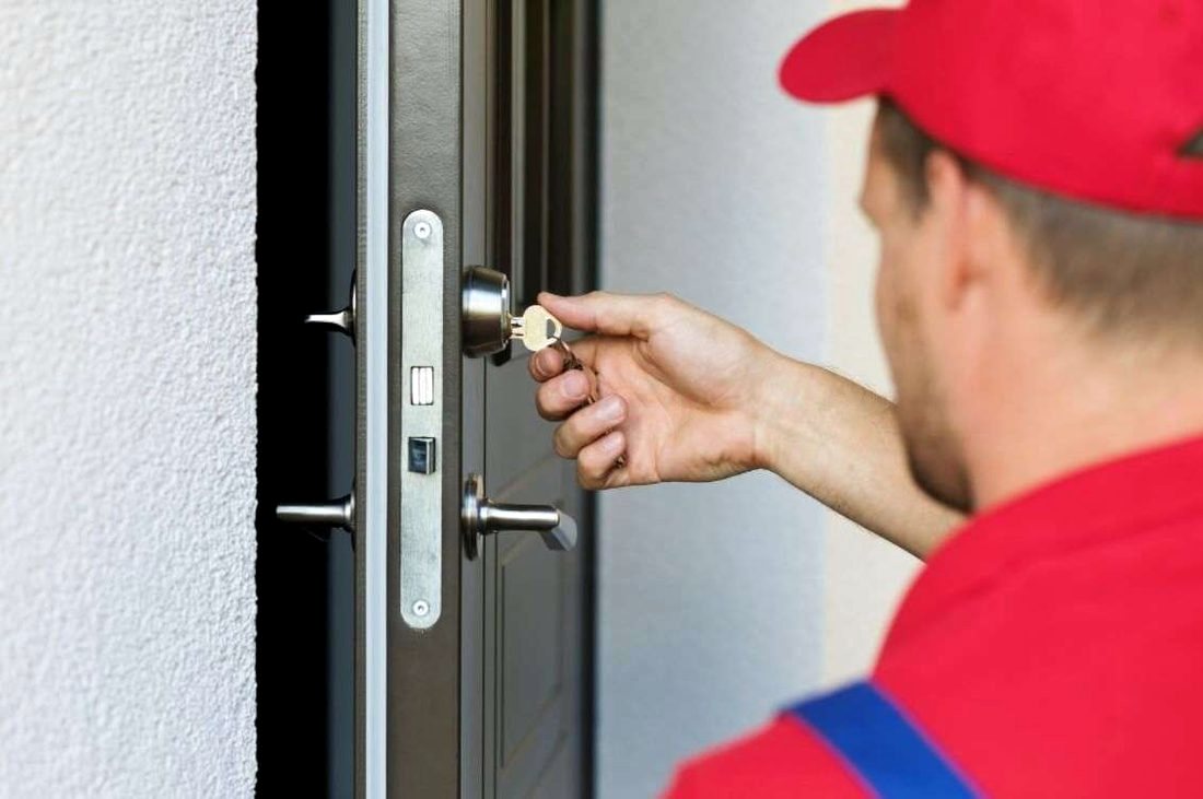 Locksmith working on an entry door cylinder